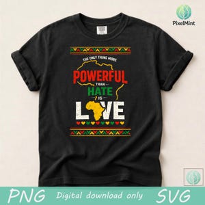 May include: Black t-shirt featuring the message "The only thing more powerful than hate is love." The design incorporates a map of Africa and decorative borders in red, yellow, and green. The shirt is a Comfort Colors brand.