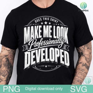 May include: A black short-sleeved t-shirt featuring white graphic text that reads: DOES THIS SHIRT MAKE ME LOOK Professionally DEVELOPED. The design is arranged in a circular layout with decorative lines and stars, centered on the chest of the garment.