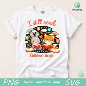 May include: White t-shirt with a colorful graphic featuring a cartoon rabbit and fox reading books. The text "I still read Children's books" is displayed in red and orange. Rainbows, hearts, and letters complete the design.