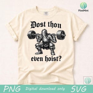 Puede incluir: Camiseta color crema con una ilustraci&oacute;n en blanco y negro de un caballero levantando una barra. El texto "Dost thou even hoist?" est&aacute; encima y debajo del caballero. La camiseta es de material suave.