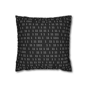 May include: Square black cushion featuring a repeating pattern of white numbers, mainly 1 and 11. The numbers are arranged in a grid, creating a modern, minimalist design. The cushion is a soft square shape.