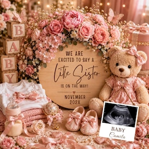 May include: A round wooden sign with the text WE ARE EXCITED TO SAY A Little Sister IS ON THE WAY! NOVEMBER 202X, surrounded by pink flowers, a teddy bear in a pink dress, baby shoes, a bottle, a rattle, and a baby ultrasound photo labeled BABY Camila.