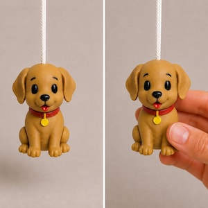 May include: A light brown puppy figurine attached to a white pull cord. The puppy has black eyes, a black nose, a red collar, and a small yellow circular tag. The puppy is in a sitting position with its mouth slightly open showing a red tongue.