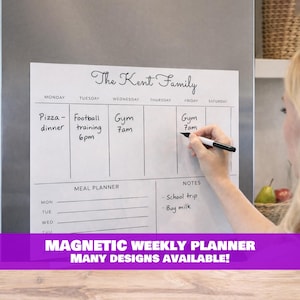 May include: A white magnetic weekly planner with the text "The Kent Family" at the top. The planner has sections for each day of the week, a meal planner, and notes. The bottom of the planner has the text "MAGNETIC WEEKLY PLANNER MANY DESIGNS AVAILABLE!"
