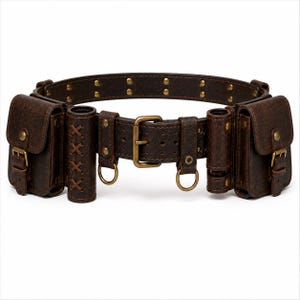 May include: A dark brown leather utility belt featuring two rectangular pouches with buckle closures, two cylindrical holders with crisscross lacing, brass hardware, metal D-rings, and a central buckle. The belt is accented with brass rivets.