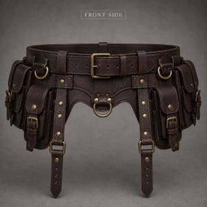 May include: A dark brown leather utility belt featuring multiple attached pouches with brass buckles and rivets. The belt includes a central buckle closure, several D-rings, and two vertical straps hanging from the front. The text FRONT SIDE is visible.
