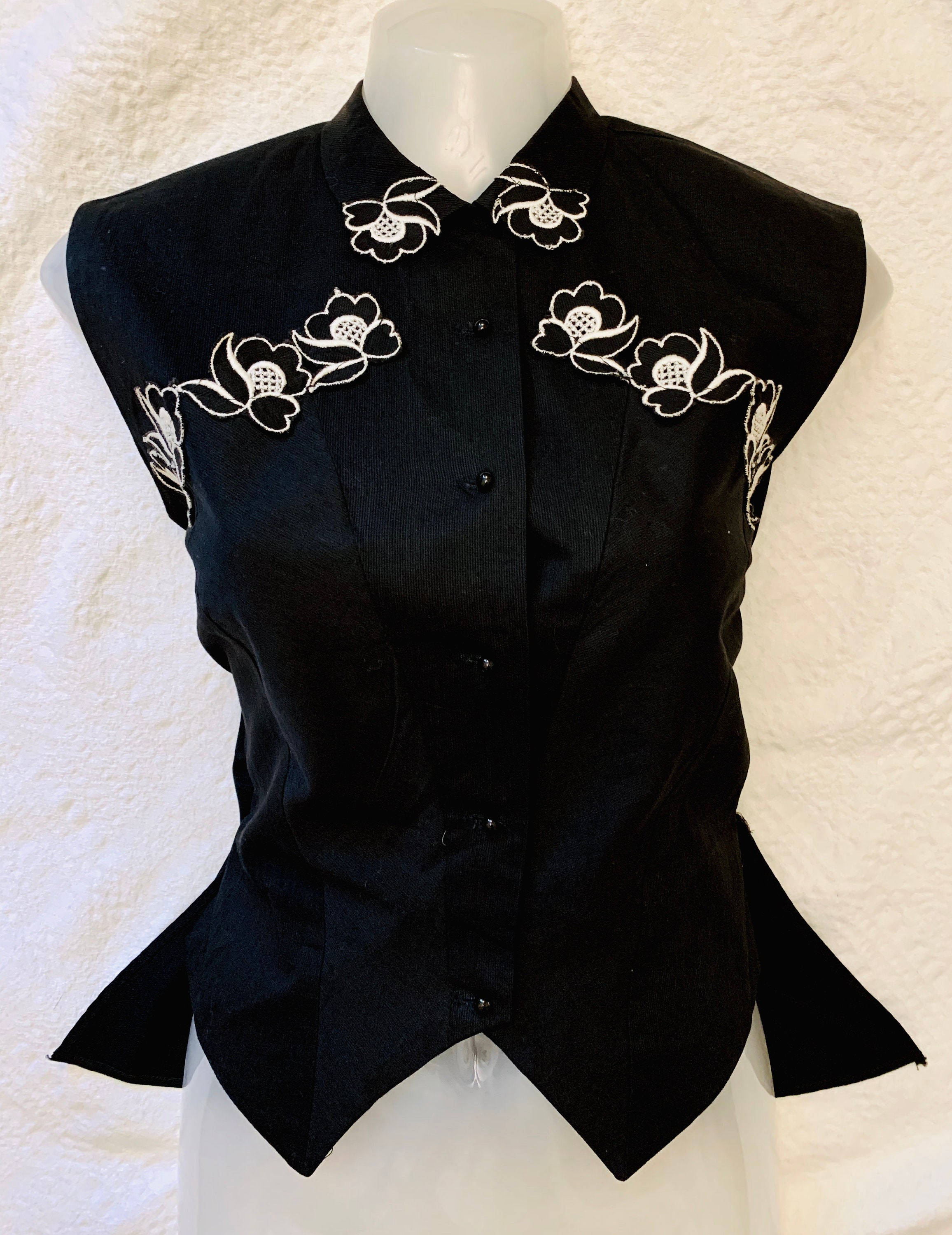Image of 's Women's Black Cotton Sleeveless Waistcoat | Vest Cut Blouse With Floral Appliqué