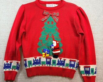 Petit pull rouge vintage avec le train du père Noël et sapin de Noël, fabriqué aux États-Unis