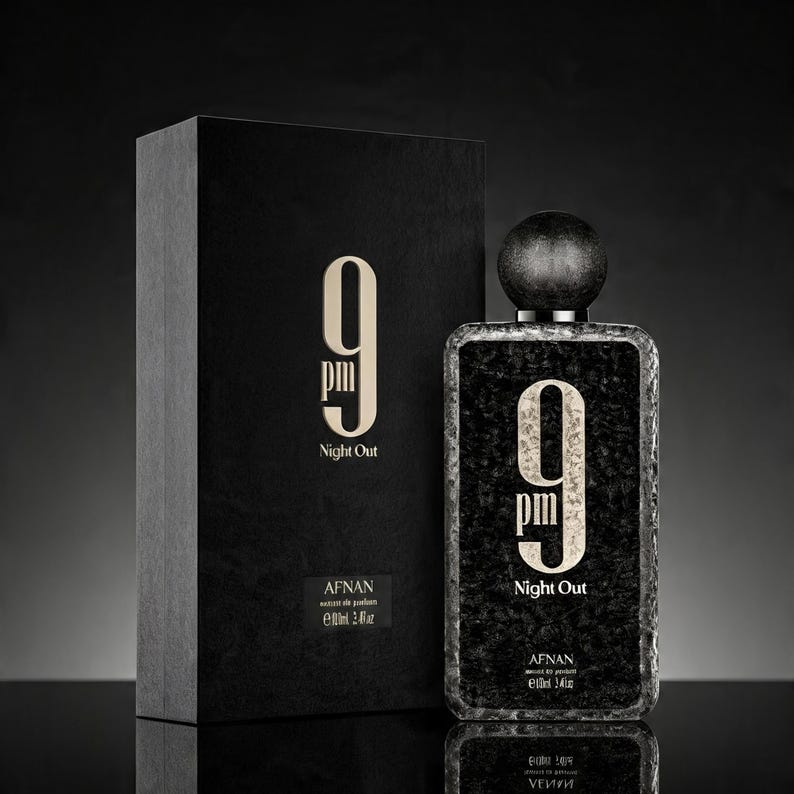 May include: A rectangular black perfume bottle and its matching box, both featuring the text 9 pm Night Out in gold lettering. The bottle has a textured black surface and a round black cap. The label indicates Afnan and 3.4 fl oz.