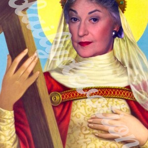 May include: An illustrated portrait of Bea Arthur, depicted as a saint, holding a cross. She wears a gold crown, a red cape, and a cream-colored dress. The text "BEA ARTHUR" is at the bottom.
