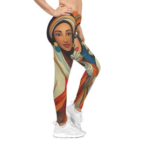 May include: Leggings featuring a vibrant, artistic design of two women with headscarves. The artwork incorporates warm colors like orange, red, and beige, with accents of blue and gold. The leggings are paired with white athletic shoes.