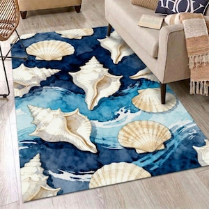 May include: A rectangular rug with a watercolour design of seashells and ocean waves. The rug has a dark blue background with white and beige seashells scattered across it. The waves are depicted in shades of blue and white.