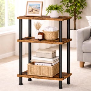 May include: A three-tiered, brown and black storage shelf. The shelves have a rustic wood grain appearance, supported by black metal poles. The top shelf holds a framed picture, a potted plant, and other decorative items. The shelf is 30 inches tall.