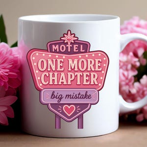 May include: A white ceramic mug featuring a graphic of a pink and purple motel sign. The sign displays the text MOTEL, ONE MORE CHAPTER, and big mistake, accented with a star at the top and a heart at the bottom, all in a retro neon style.