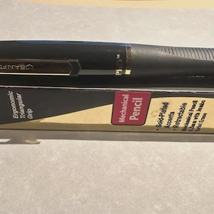 May include: Black mechanical pencil with gold-plated accents and an ergonomic triangular grip. The pencil is labelled "PhD Gold" and "Sanford". The packaging reads "Mechanical Pencil" and "Retractable".