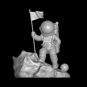 May include: A gray astronaut figurine stands on a rocky surface, holding a flag. The astronaut wears a spacesuit with a backpack. A small sphere rests near the astronaut's foot. The background is black.