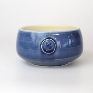 Porcelain matcha bowl Available in green or blue Adorned with a tea leaf stamp Handmade in Canada Blue