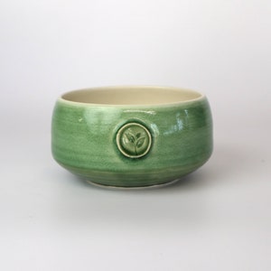 Porcelain matcha bowl Available in green or blue Adorned with a tea leaf stamp Handmade in Canada Green