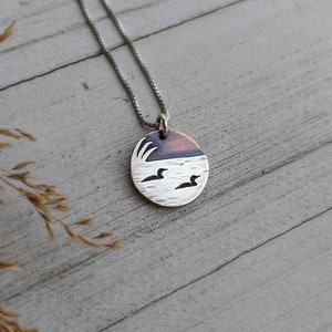 Loons on the lake - mixed metal loon wildlife pendant necklace