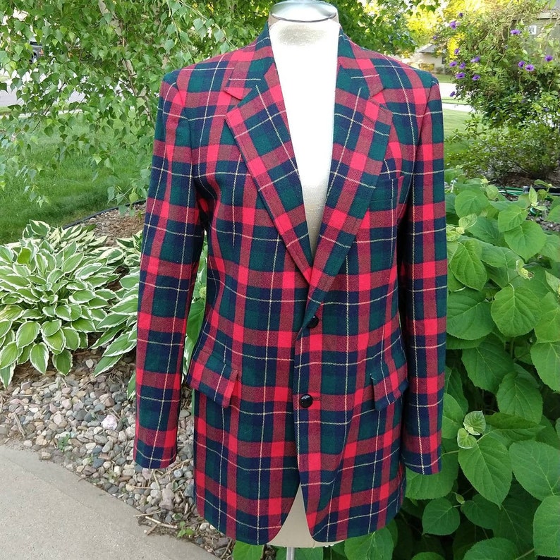 May include: A red, green, and yellow plaid blazer with a single button closure.