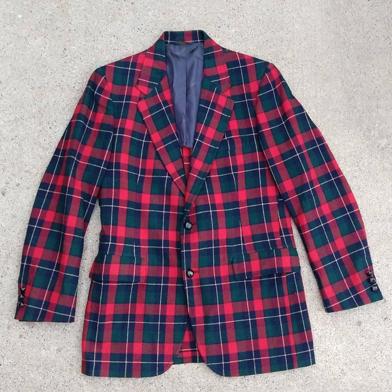 May include: A red, green, and white plaid blazer with a single button closure.