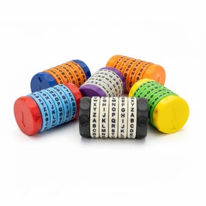 May include: A collection of five cylindrical alphabet code wheels, each featuring rotating rings with black letters A through Z. The devices are colored in blue and red, orange and blue, purple and white, green and yellow, and black and white.