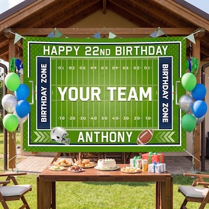 May include: A rectangular green football field banner featuring the text HAPPY 22ND BIRTHDAY, YOUR TEAM, and ANTHONY. The design includes white yard lines, numbers, and dark blue end zones labeled BIRTHDAY ZONE, with a football helmet and ball.