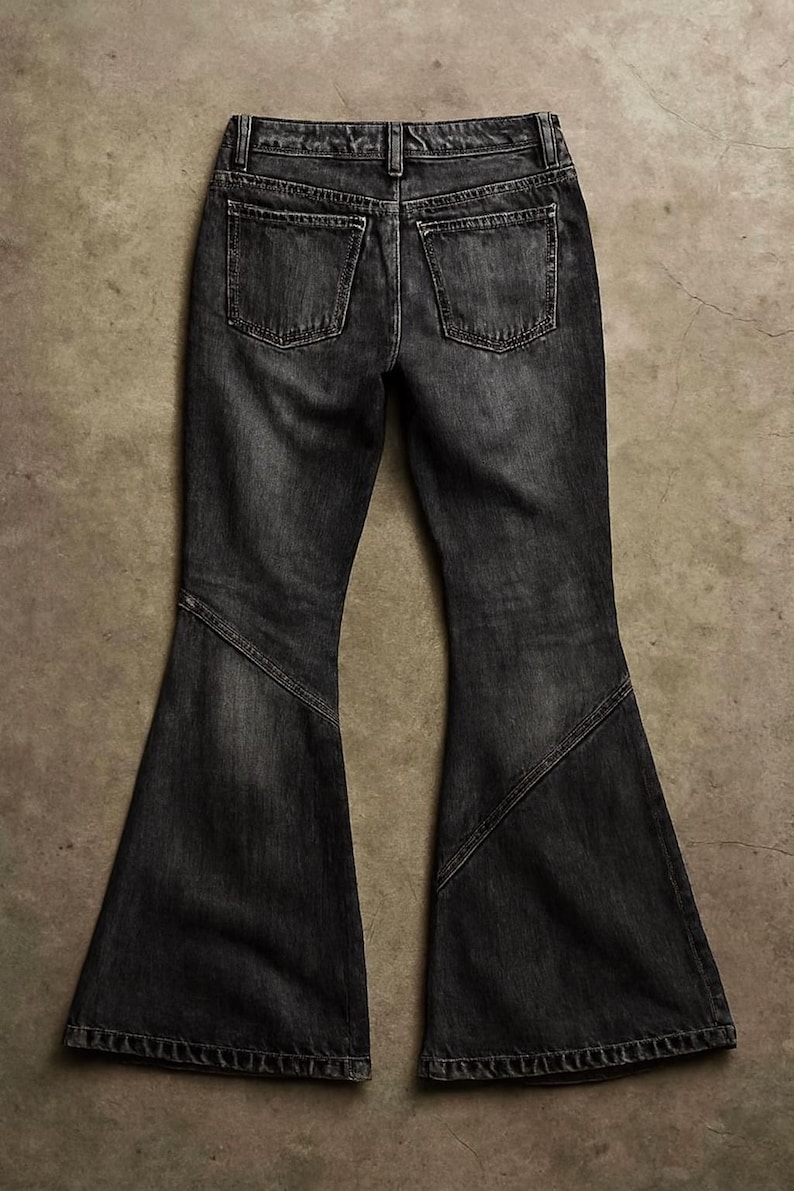 May include: Dark gray denim jeans with a flared leg design. The jeans have two back pockets and a classic five-pocket style. The fabric appears to be a medium weight denim.