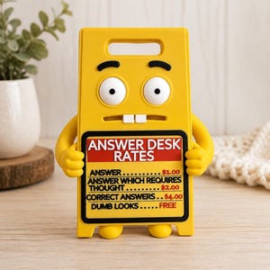 May include: A yellow plastic sign shaped like a cartoon character with wide eyes and two teeth. The sign features the text: ANSWER DESK RATES, ANSWER $1.00, ANSWER WHICH REQUIRES THOUGHT $2.00, CORRECT ANSWERS $4.00, DUMB LOOKS FREE, with a black border.