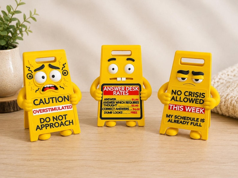 May include: Three yellow plastic caution signs with cartoon faces and arms. The left sign reads CAUTION OVERSTIMULATED DO NOT APPROACH. The center sign reads ANSWER DESK RATES with a price list. The right sign reads NO CRISIS ALLOWED THIS WEEK.
