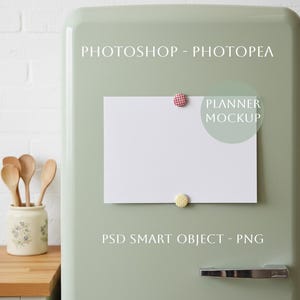 May include: A white rectangular planner mockup is attached to a light green refrigerator door with two decorative magnets. The text "PHOTOSHOP - PHOTOPEA" and "PSD SMART OBJECT - PNG" are printed on the door. A ceramic jar with wooden spoons is on a wooden surface.