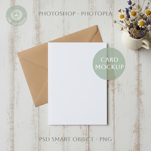 May include: A blank white card and a brown envelope on a light wood-grain surface. The words "CARD MOCKUP" are in a green circle. A small vase of dried flowers is to the right. The text "PHOTOSHOP - PHOTOPEA" and "PSD SMART OBJECT - PNG" are also visible.