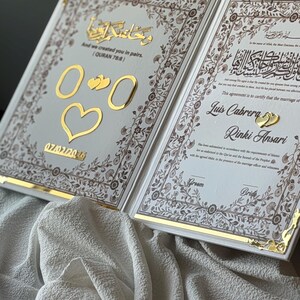May include: Open wedding invitation with gold accents and floral border. The text includes Arabic script and English phrases, with the names Luis Cabrera and Rinki Ansari. The date 07/02/2016 is also visible.
