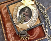 Highly tinted tin type young girl in pink hair ribbons assemblage pendant necklace jewelry early photography memento mori steampunk cheeks