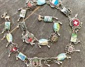 Souvenir link world traveler necklace assemblage jewelry bracelet panel  enamel Tommoores Tavern Karnten Siam Niello Bermuda  Switzerland