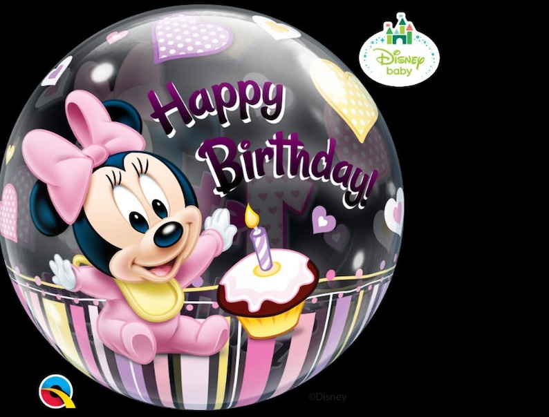 May include: A clear, round balloon featuring a cartoon image of Minnie Mouse in a pink outfit. The balloon has the words "Happy Birthday!" and heart shapes. A cupcake with a lit candle is also visible.