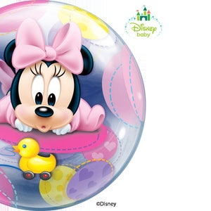 May include: A Disney Baby bubble balloon featuring Minnie Mouse in a pink outfit and bow. The balloon has a clear background with pastel shapes and a yellow toy duck. The Disney Baby logo is visible.