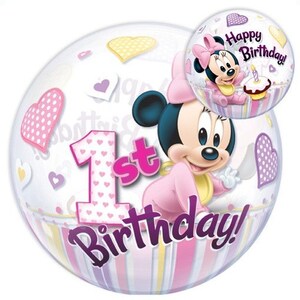 May include: A clear bubble balloon featuring Minnie Mouse in a pink outfit, with the text "1st Birthday!" and "Happy Birthday!". The balloon is decorated with hearts and a striped pattern in pink, purple, and yellow.