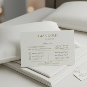 May include: White bedding set with a pillow and folded sheets. A card reads "GIZA GOLD by Samara" with care instructions. The set is made of premium Egyptian cotton with a 500 thread count.