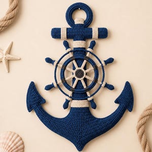 May include: A crochet wall hanging featuring a large navy blue anchor with beige accents. A smaller navy blue and beige ship wheel is attached to the center of the anchor. The design is crafted with visible yarn stitches in a nautical style.