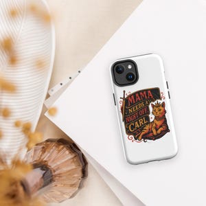 May include: A white smartphone case featuring a graphic illustration of a cat wearing a crown and collar, resting on a cushion. The design includes a sword and the text MAMA NEEDS A NIGHT OFF, CARL in a stylized, dark-toned rectangular frame.