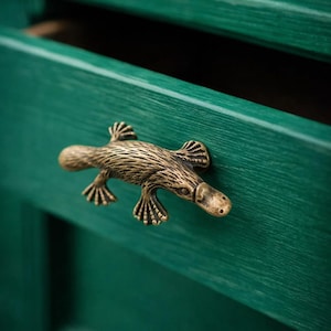 May include: A white ceramic mug with a black handle and the text "But First, Coffee" in a black, bold font. The mug is on a white surface. The mug is approximately 4 inches tall.