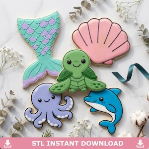 May include: An assortment of decorated sugar cookies in the shape of sea creatures. The cookies include a mermaid tail, seashell, turtle, octopus, and dolphin. The cookies are decorated with pastel colors and black outlines. Text on the image reads "STL INSTANT DOWNLOAD".