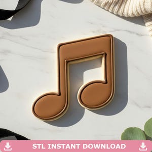 May include: A brown cookie in the shape of a musical eighth note. The cookie has a light brown border and a darker brown filling. The text "STL INSTANT DOWNLOAD" is at the bottom of the image.