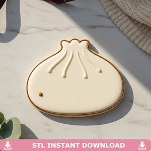 May include: A cream-colored dumpling-shaped cookie with brown trim and embossed details. The cookie has a small brown dot and is set on a marble surface. The text "STL INSTANT DOWNLOAD" is at the bottom.