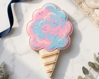 May include: A cotton candy-shaped cookie with a pink, blue, and white swirl design. The cookie is shaped like an ice cream cone, with a beige cone and brown stripes. The text "STL INSTANT DOWNLOAD" is at the bottom.
