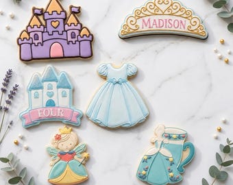 May include: Assortment of decorated cookies in a princess theme. Includes a castle, a tiara with the name "Madison", a dress, a cookie with the word "FOUR", a fairy, and a dress-shaped cookie with a teacup. The cookies are decorated with pastel colors.