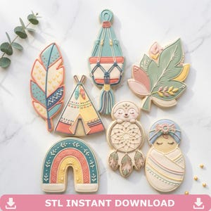 May include: A collection of boho-themed cookies, including a feather, a teepee, a rainbow, a leaf, a hanging planter, a dreamcatcher, and a swaddled baby. The cookies are decorated with pastel colors and intricate details. The text "STL INSTANT DOWNLOAD" is at the bottom.