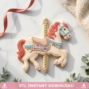 May include: A carousel horse biscuit with pink, blue, and cream-coloured icing. The biscuit features a detailed design of a carousel horse with a pink mane and tail, blue bridle, and a pink and blue saddle. The text "STL INSTANT DOWNLOAD" is at the bottom.