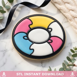 May include: A round cookie decorated with smooth icing in a puzzle piece pattern. The design features segments in yellow, white, pink, and blue, all outlined with thick black icing. The center is a white oval, and the text reads STL INSTANT DOWNLOAD.